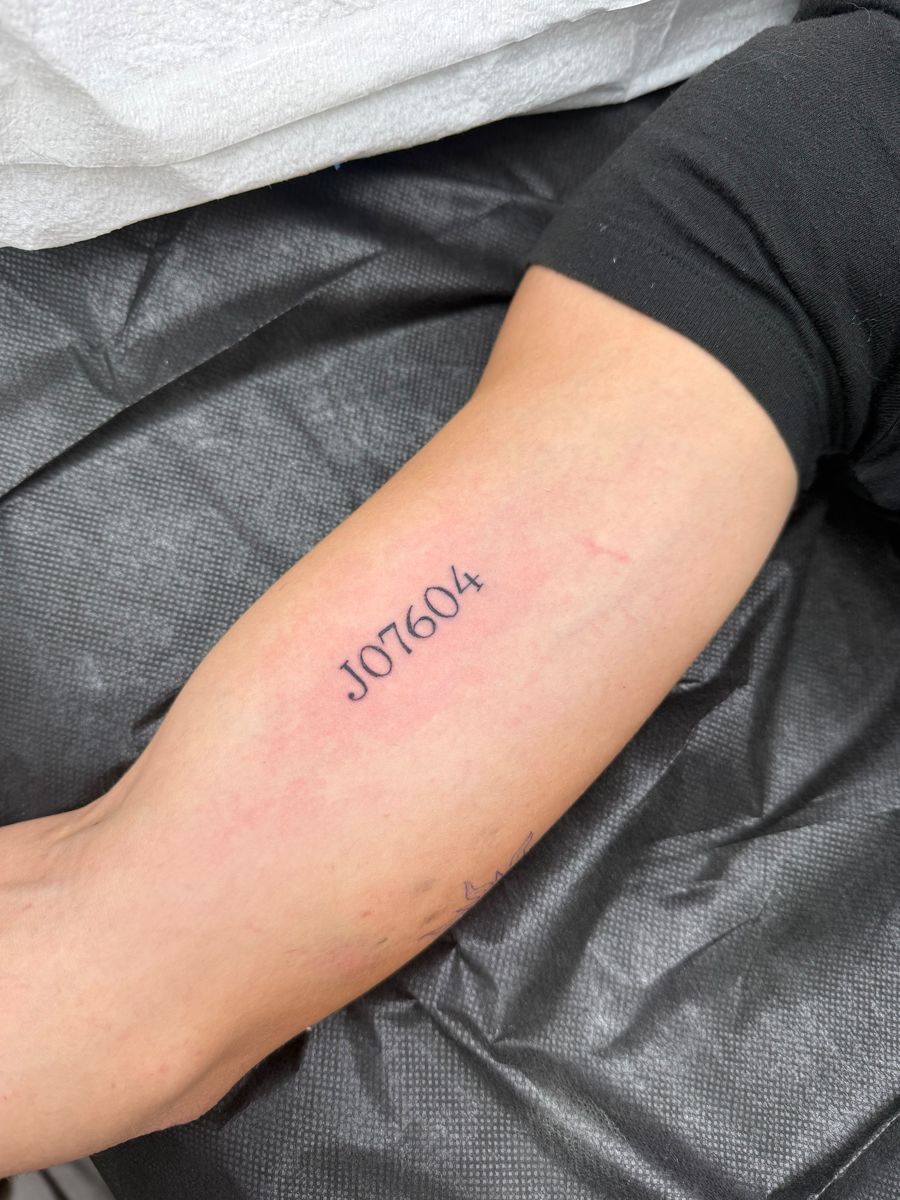 Horse registration number J07604 in small type on the inner arm — fine line tattoo by Aline at Diamond Mind Tattoo, Buzzards Bay