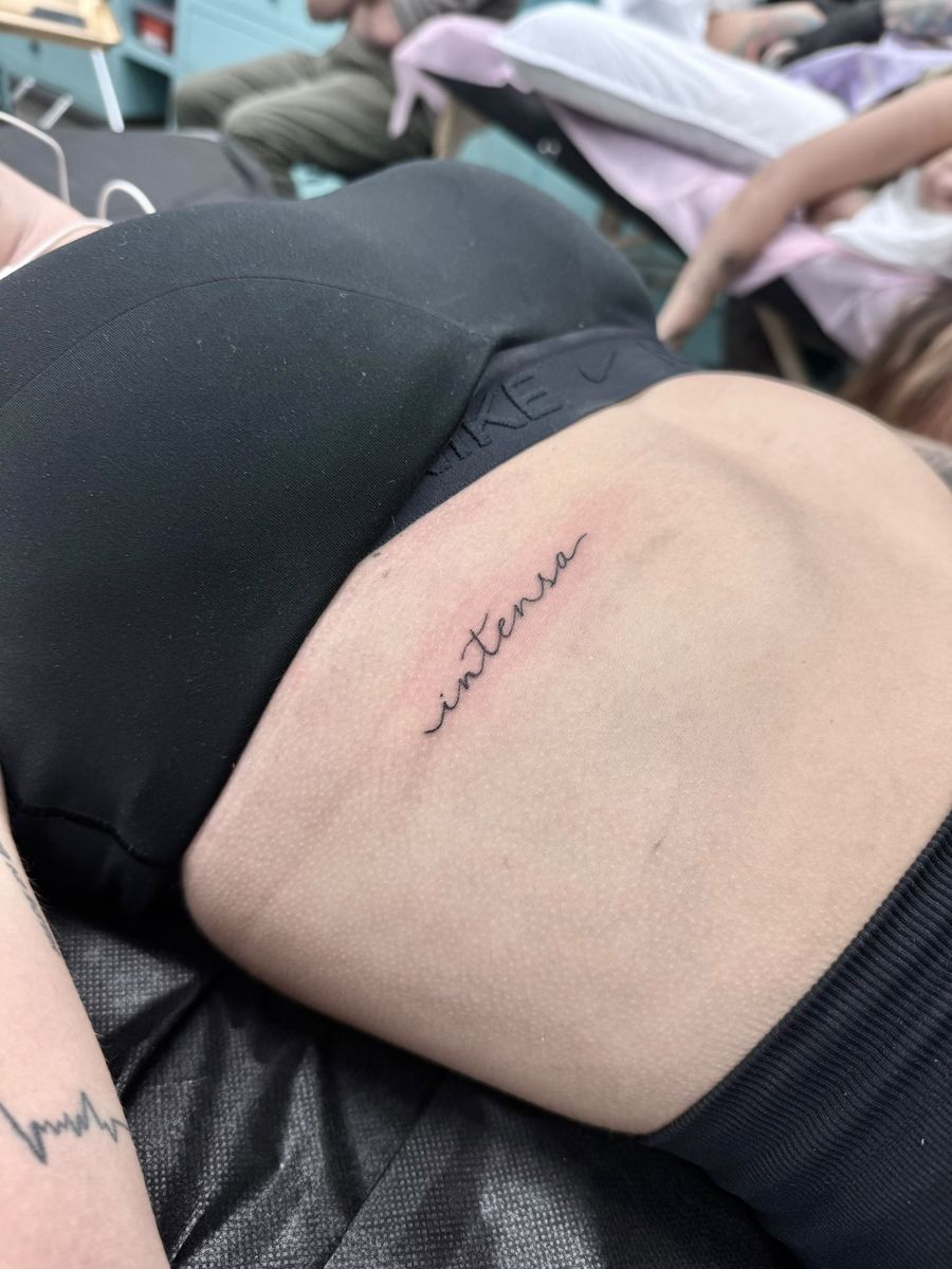 “Intensa” script on the ribs — fine line tattoo by Aline at Diamond Mind Tattoo, Buzzards Bay