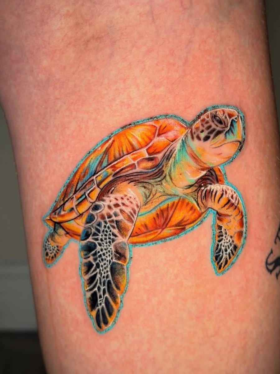 Sea turtle with an orange shell and teal outline on the leg, color realism tattoo by Brendon at Diamond Mind Tattoo, Buzzards Bay