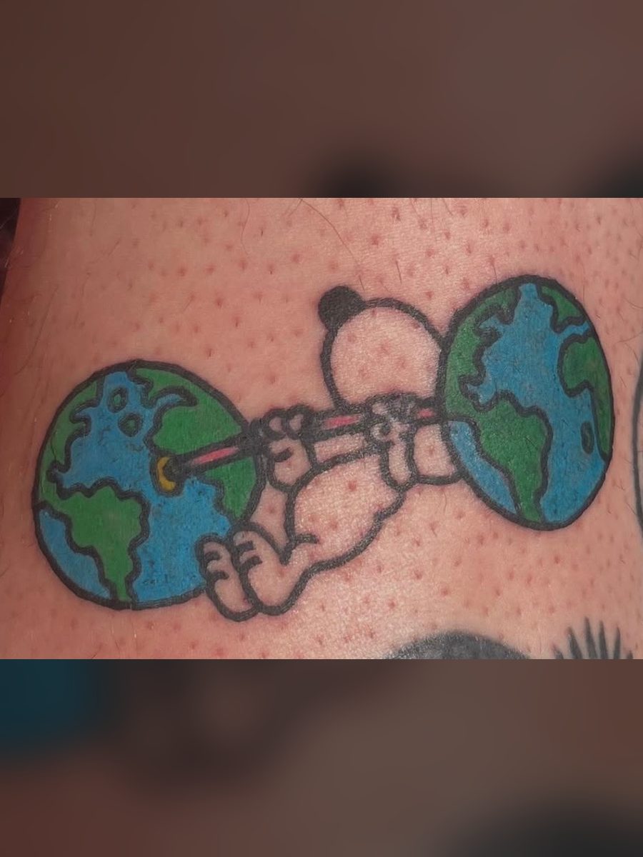 Cartoon dog lifting a barbell made of two globes, American Traditional tattoo by Chris at Diamond Mind Tattoo, Buzzards Bay