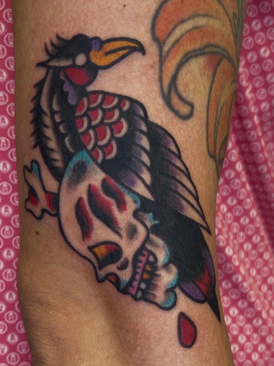 Vulture holding a skull with a blood drop, American Traditional tattoo by Chris at Diamond Mind Tattoo, Buzzards Bay
